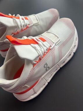 On Running Sneakers in White with Bright Orange Accents